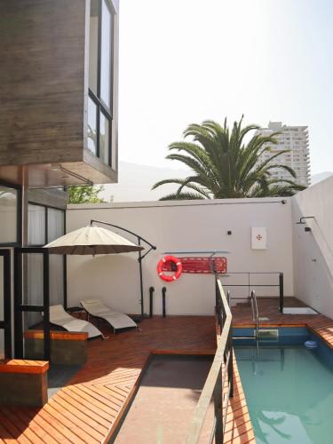 a swimming pool on the roof of a building at Hostal Litoral in Iquique