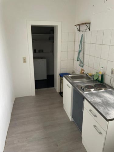a kitchen with a sink and a counter top at Dill Apartments Gr. Lafferde in Ilsede