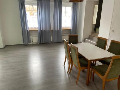 a dining room with a table and chairs at Dill Apartments Gr. Lafferde in Ilsede