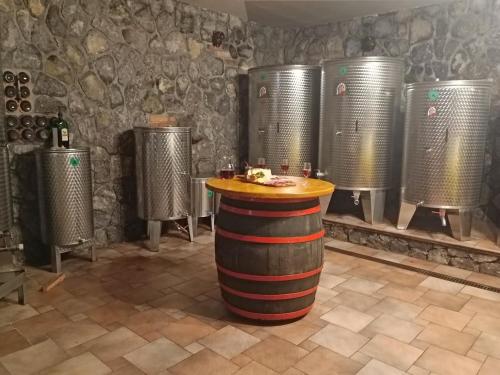 a wine tasting room with wine barrels and a table at zidanica Bunderšek in Šentjanž