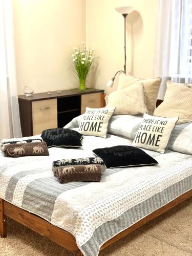a bed with pillows on it in a room at Apartament "Marka" in Piła