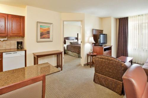 a hotel room with a couch and a living room at Staybridge Suites - Kansas City-Independence by IHG in Independence