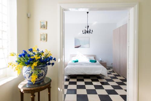 a bedroom with a bed and a vase of flowers on a table at Beautiful Villa with Breathtaking Views in Swieqi by 360 Estates in Is-Swieqi