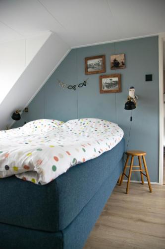 a bed with polka dots on it in a bedroom at huisje de Strandjutter in Katwijk aan Zee