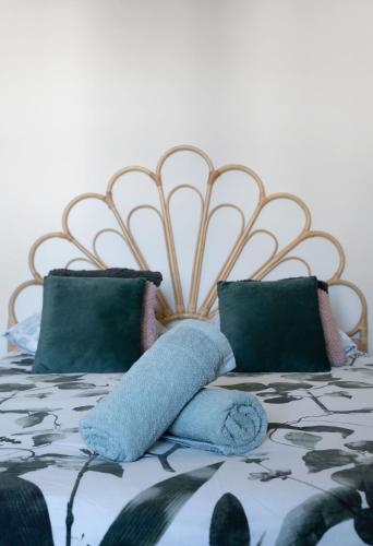 a bed with blue pillows on top of it at La Grande Maison Gannat in Gannat