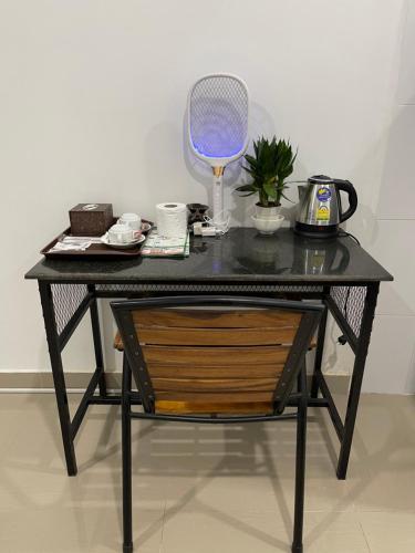 a black table with a chair and a mirror at Mother’s House in Battambang
