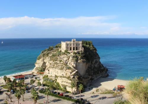 a castle on top of a rock in the ocean at Le Palme Bed And Breakfast in Briatico