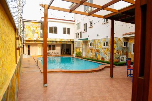 a swimming pool in the middle of a building at Midindi Hotel in Accra