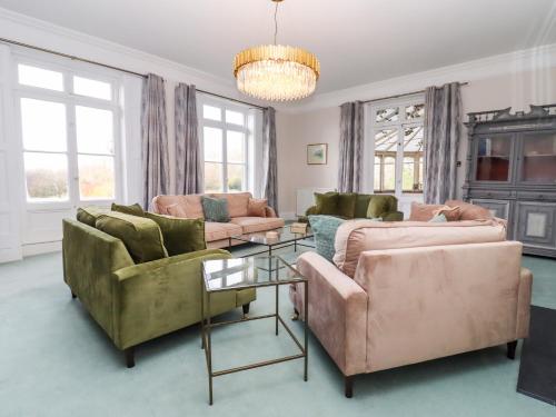 a living room with two couches and a table at The Downwood in Blandford Forum