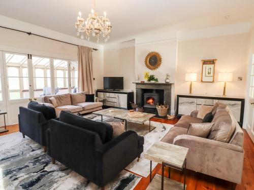 a living room with couches and a fireplace at The Downwood in Blandford Forum