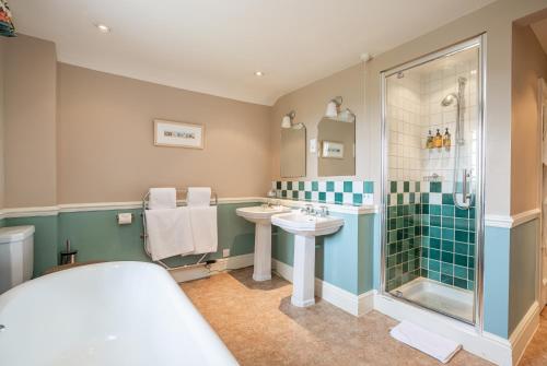 a bathroom with a sink and a shower at Castle Of Comfort Hotel in Nether Stowey