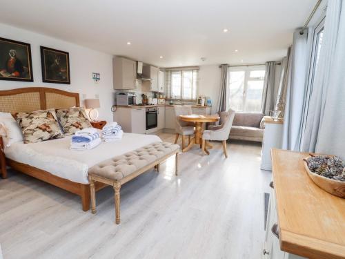 a bedroom with a bed and a living room at Meadow in Blandford Forum