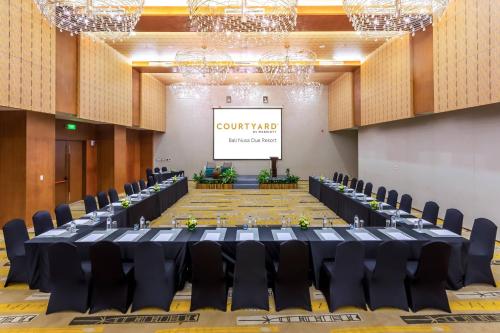 a conference room with a long table and chairs at Courtyard by Marriott Bali Nusa Dua Resort in Nusa Dua