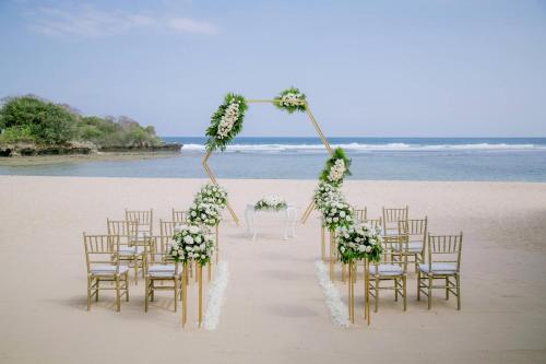 a wedding ceremony set up on the beach at Courtyard by Marriott Bali Nusa Dua Resort in Nusa Dua