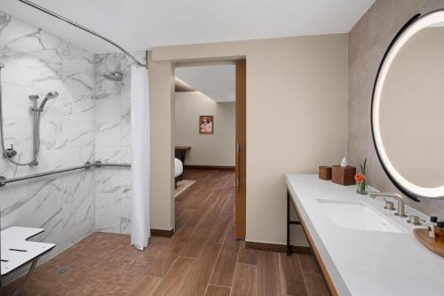 a bathroom with a sink and a mirror at The Ben, Autograph Collection in West Palm Beach