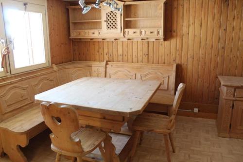 a wooden dining room with a wooden table and chairs at Ferienhaus, Stöckli Klingenbuch 20 in Rehetobel
