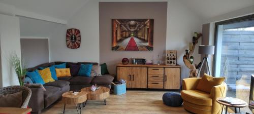 a living room with a couch and a table at LANDLOFT am Paradies in Westerstede