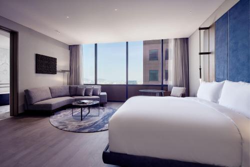 a hotel room with a bed and a couch at The Ritz-Carlton, Mexico City in Mexico City