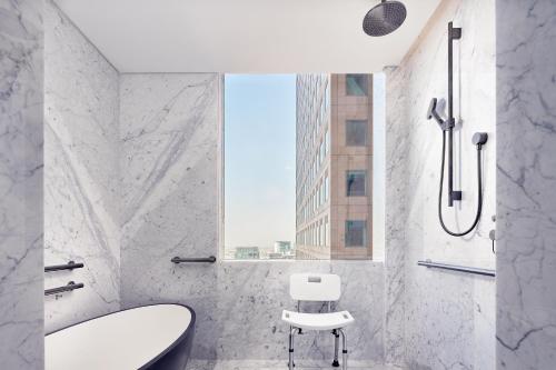 a bathroom with a tub and a sink and a chair at The Ritz-Carlton, Mexico City in Mexico City
