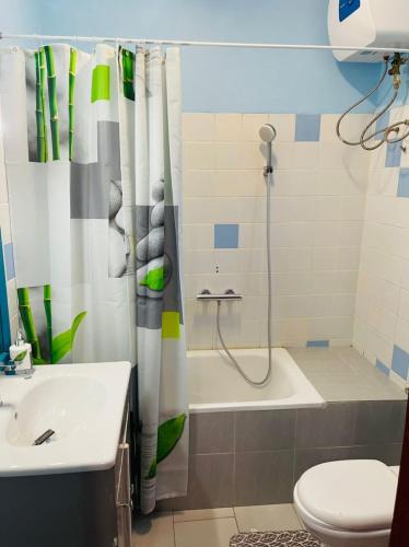 a bathroom with a shower and a toilet and a sink at Résidence Karamel Yaoundé Anguissa in Yaoundé