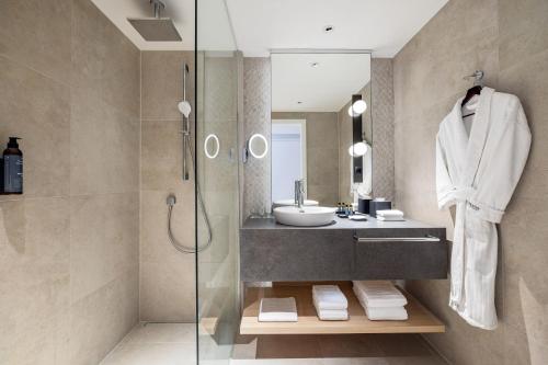 a bathroom with a sink and a shower at The Westin Grand Frankfurt in Frankfurt/Main