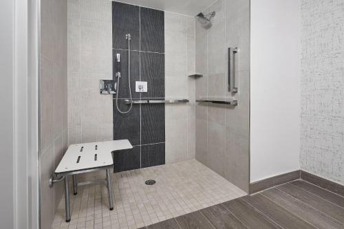 a shower with a bench in a bathroom at Orlando Marriott Lake Mary in Lake Mary