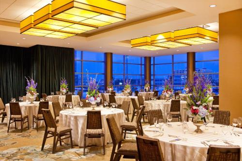 a banquet hall with tables and chairs and windows at The Westin Boston Seaport District in Boston