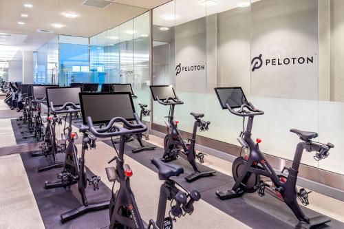 a gym with a row of treadmills and exercise bikes at The Westin Boston Seaport District in Boston