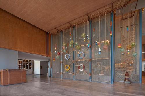 a glass wall in a building with a window at Four Points by Sheraton Tianjin National Convention and Exhibition Center in Tianjin