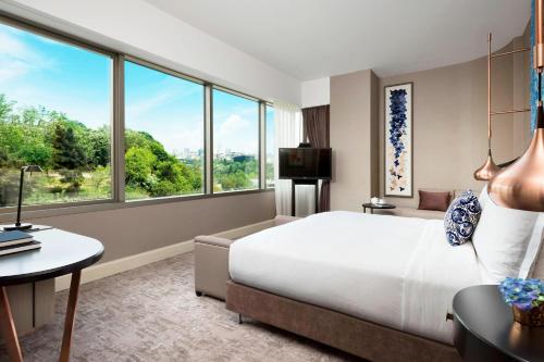 a hotel room with a bed and a large window at The Ritz-Carlton, Istanbul at the Bosphorus in Istanbul