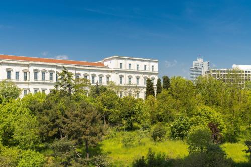 a large white building with trees in front of it at The Ritz-Carlton, Istanbul at the Bosphorus in Istanbul
