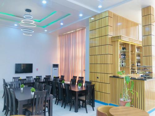 a dining room with a table and chairs at Dalchifit Suites by Premium Swiss Hospitality in Abuja