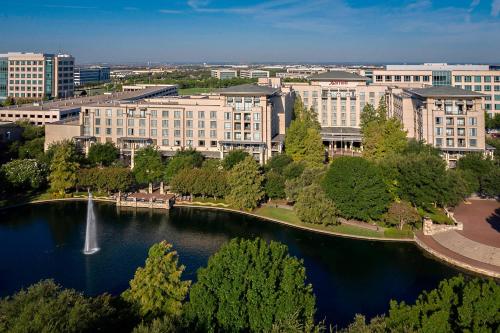 an aerial view of a city with a fountain in a lake at Dallas/Plano Marriott at Legacy Town Center in Plano