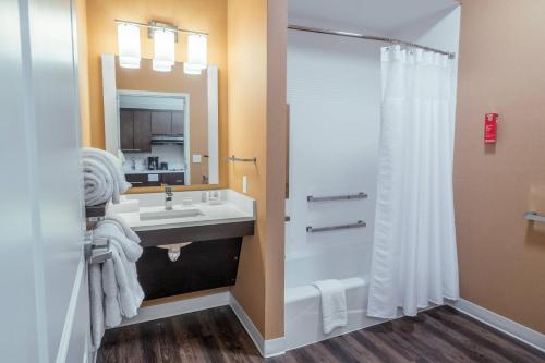 a bathroom with a sink and a shower at TownePlace Suites by Marriott Toledo Oregon in Oregon