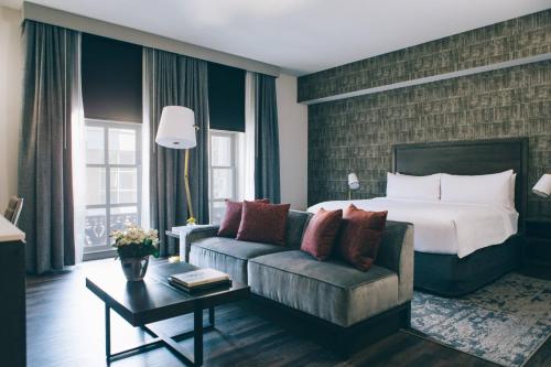 a hotel room with a bed and a couch at Marriott St. Louis Grand in Saint Louis