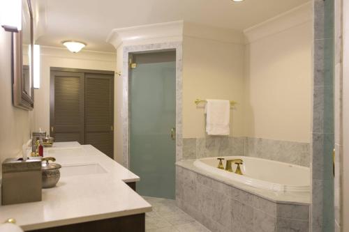 a bathroom with a bath tub and a sink at Marriott St. Louis Grand in Saint Louis