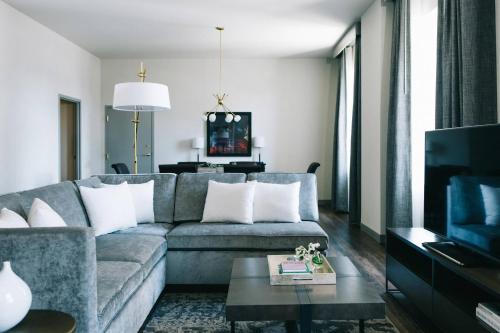 a living room with a couch and a tv at Marriott St. Louis Grand in Saint Louis