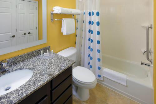 a bathroom with a sink and a toilet and a shower at TownePlace Suites Joplin in Joplin