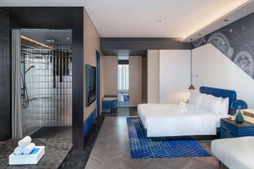 a hotel room with a bed and a shower at W Changsha in Changsha