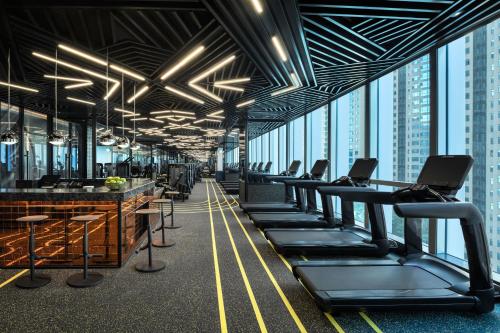 an office with a row of chairs and tables and windows at W Changsha in Changsha