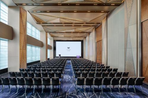 an empty room with chairs and a projection screen at W Changsha in Changsha