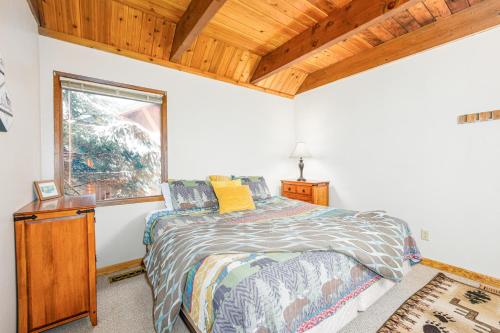 a bedroom with a bed and a window at Snowbird Chalet #5 in Girdwood