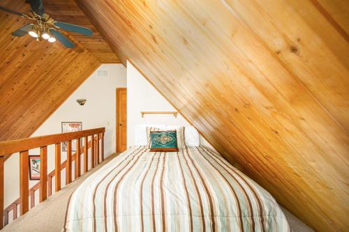 a bed in a room with a wooden ceiling at Snowbird Chalet #5 in Girdwood