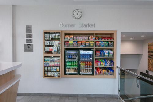 a counter in a store with a clock on the wall at Fairfield Inn by Marriott JFK Airport in Queens