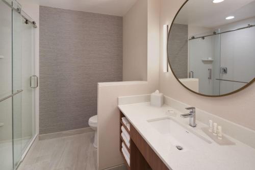 a bathroom with a sink and a mirror at Fairfield by Marriott Inn & Suites West Palm Beach in West Palm Beach