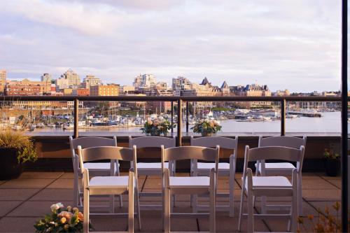 a balcony with chairs and a view of a harbor at Delta Hotels by Marriott Victoria Ocean Pointe Resort in Victoria