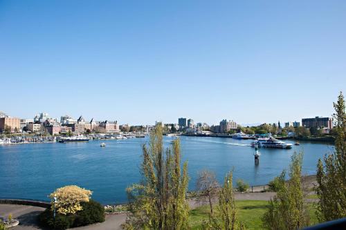 a view of a river with boats in a city at Delta Hotels by Marriott Victoria Ocean Pointe Resort in Victoria