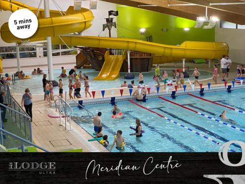 a group of people in a swimming pool at iLodge Ultra in Louth