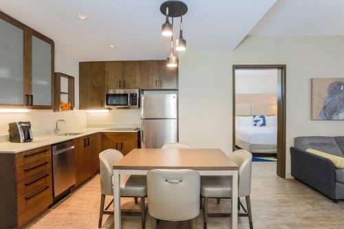a kitchen and dining room with a table and chairs at Residence Inn by Marriott Dallas Frisco in Frisco