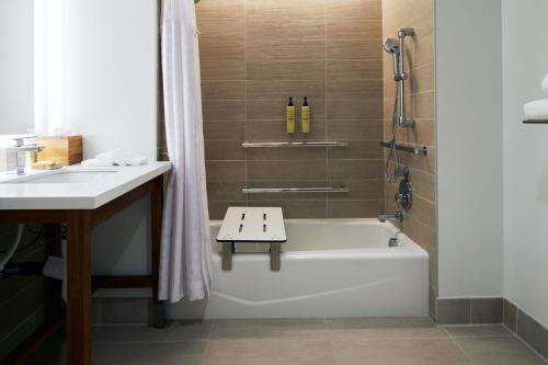 a bathroom with a bath tub and a sink at Element Irvine in Irvine